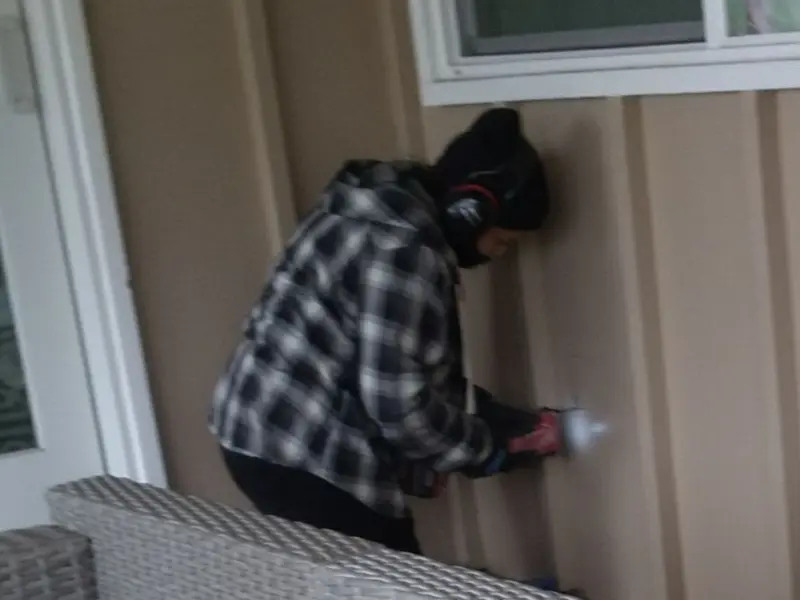 Professional electrician installing an exterior outlet in West Branch
